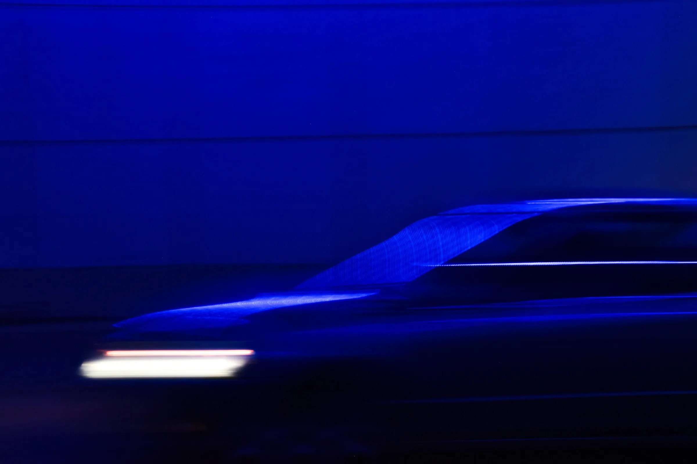 A car moving through blue light at night